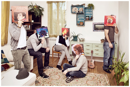 Band on a room covering with famous vinyl records.