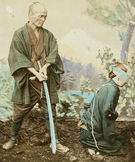Samurai executioner, beheading was the most common form of capital punishment in Japan. The criminal kneeled on a mat placed in front of a rectangular pit about 2 or 3 feet deep. He was usually blindfolded and stretched his head over the pit, the executioner whisked off the wretched man’s head at one blow. He was a well known practitioner with a very tolerable income. He received some 7 ichiboos (about $2.30) per head, and had taken off as many as 350 heads in a 12 months.