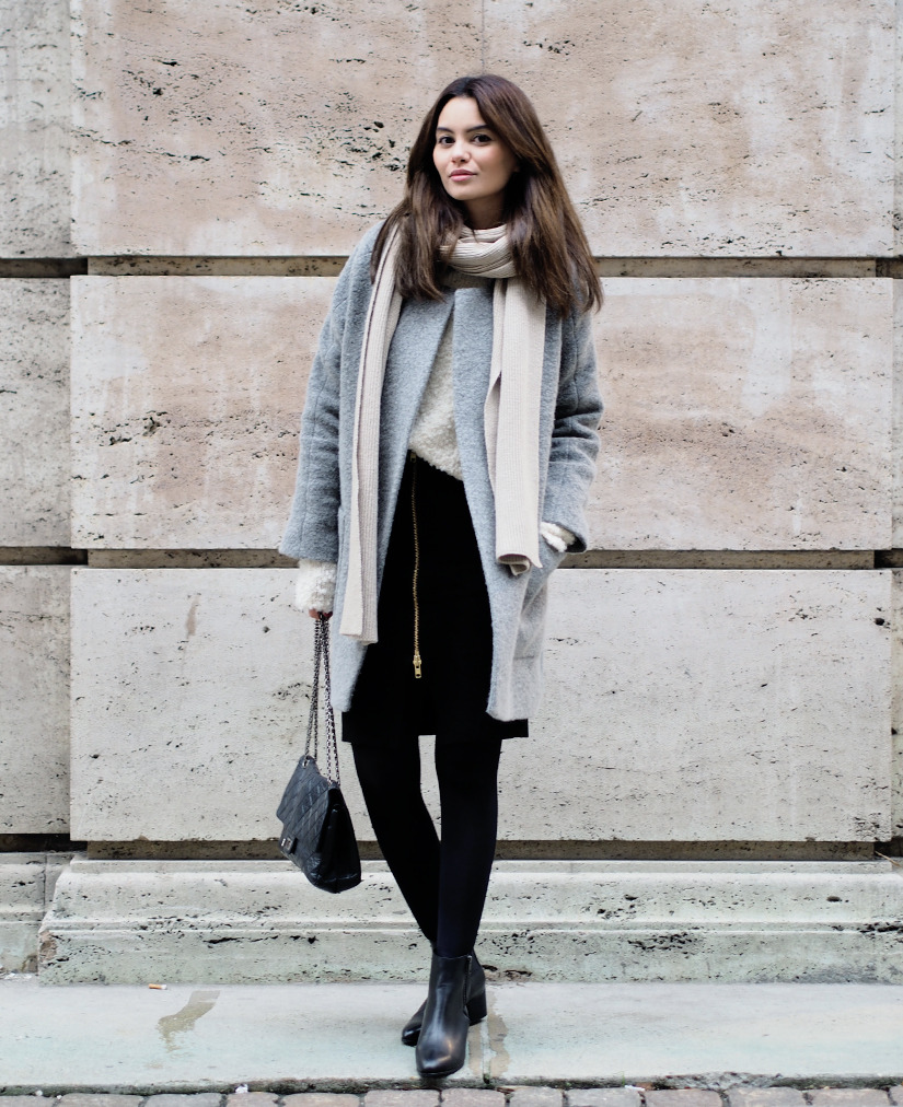 Funda Christophersen is wearing a grey coat from Sand, jumper from Ganni, scarf from Toteme, black skirt from Envii, bag from Chanel and the ankle boots are from Opening Ceremony