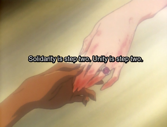 Image: Anthy finally taking Utena’s outstretched hand, their fingers just beginning to brush each other. Text: Solidarity is step two. Unity is step two.