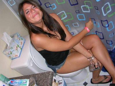 Girl sitting on toilet peeing