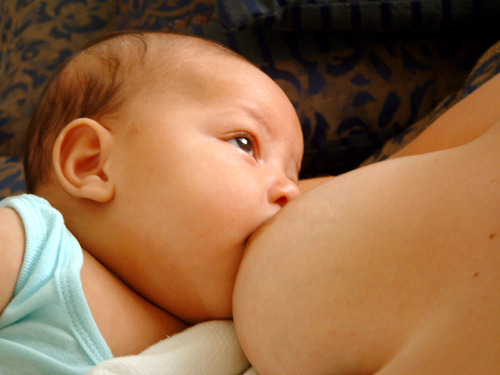 Black mother breastfeeding baby